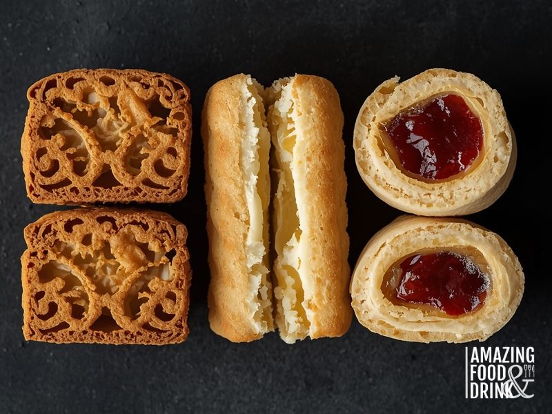 Cross-sections of international filled cookies showing Chinese mooncake with lotus paste and egg yolk, Alfajores with dulce de leche, and Rugelach with jam filling