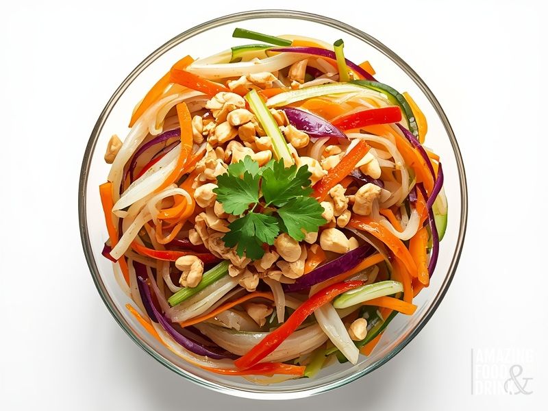 Vietnamese glass noodle salad with transparent noodles, colourful julienned vegetables, and crushed peanuts