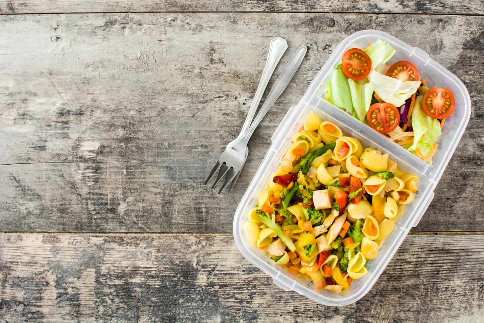 33080168 lunch box with healthy food ready to eat pasta salad on wooden table