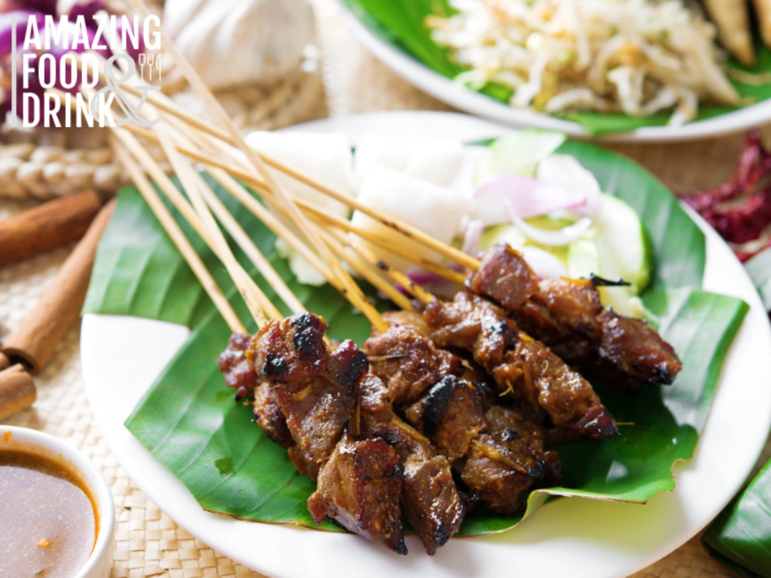 Satay or sate, skewered and grilled meat, served with peanut sauce, cucumber and ketupat, Malaysia or Indonesia food. Traditional Malay food. Hot and spicy Malaysian dish, Asian cuisine.