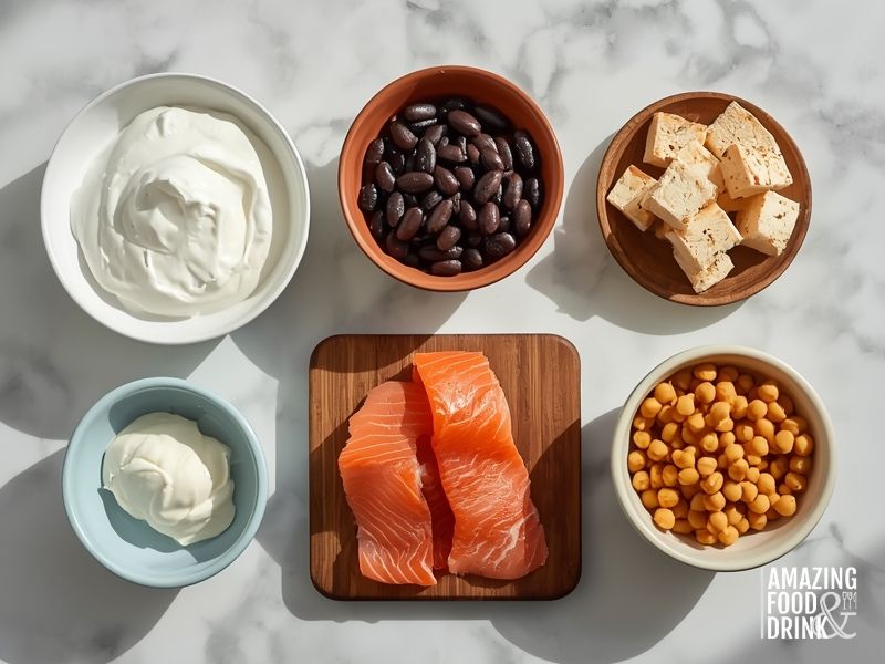 Comparison of protein-rich egg-free breakfast ingredients including Greek yoghurt, black beans, tofu, smoked salmon, and chickpeas in individual bowls