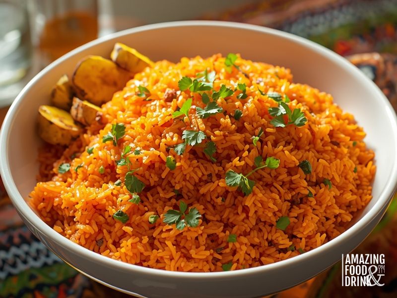 West African Jollof rice with vibrant orange-red colour served with fried plantains and fresh herbs